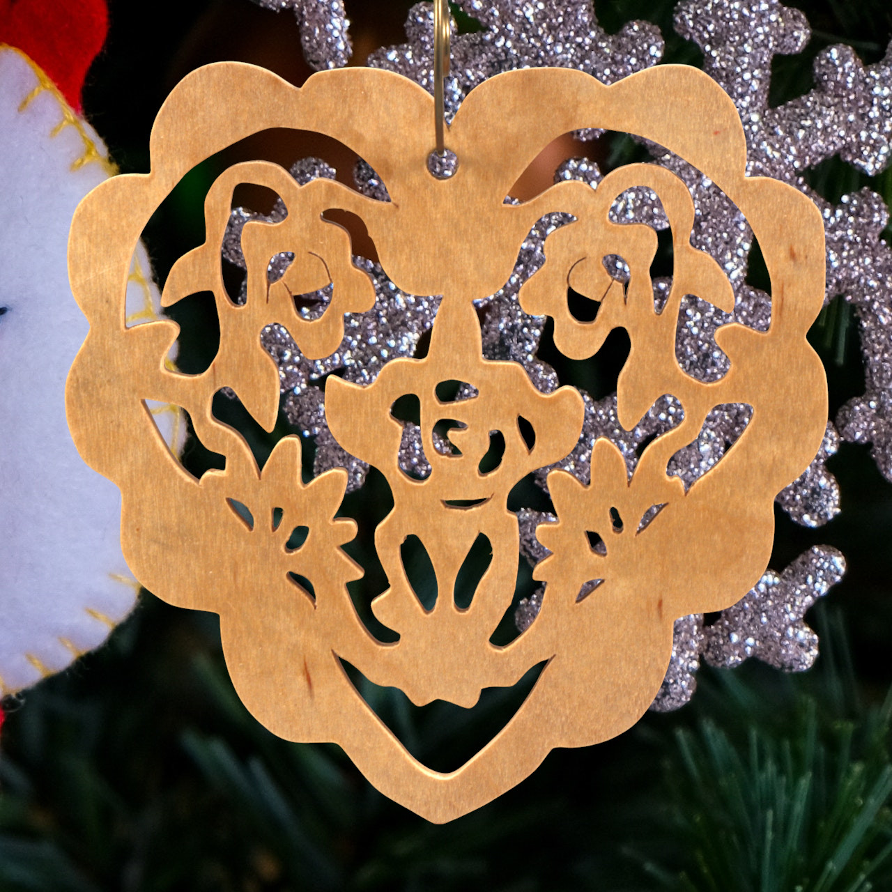 A handmade wooden Victorian-style fretwork floral heart Christmas tree ornament, featuring intricate cutout floral patterns in a heart shape, with a warm natural wood finish.