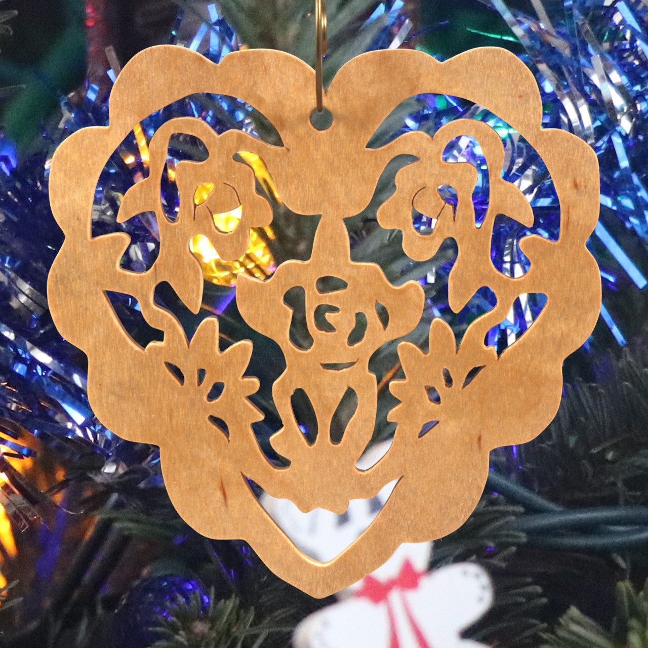 A handmade wooden Victorian-style fretwork floral heart Christmas tree ornament, featuring intricate cutout floral patterns in a heart shape, with a warm natural wood finish.
