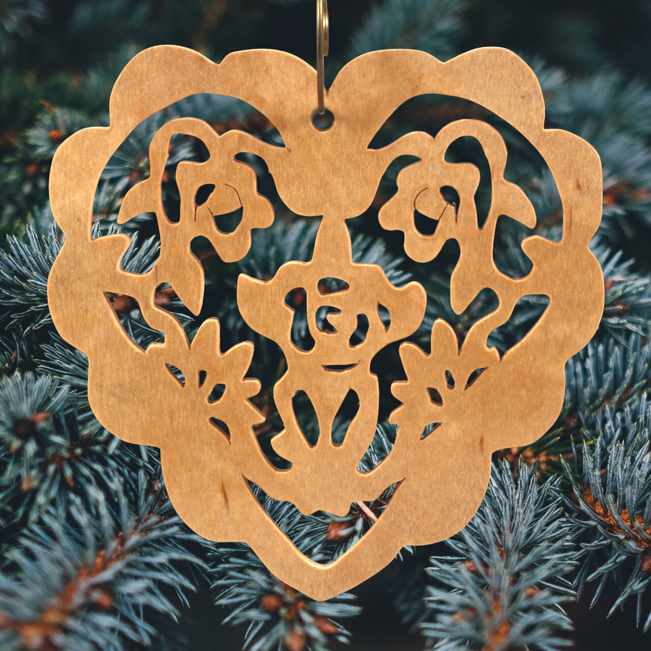 A handmade wooden Victorian-style fretwork floral heart Christmas tree ornament, featuring intricate cutout floral patterns in a heart shape, with a warm natural wood finish.