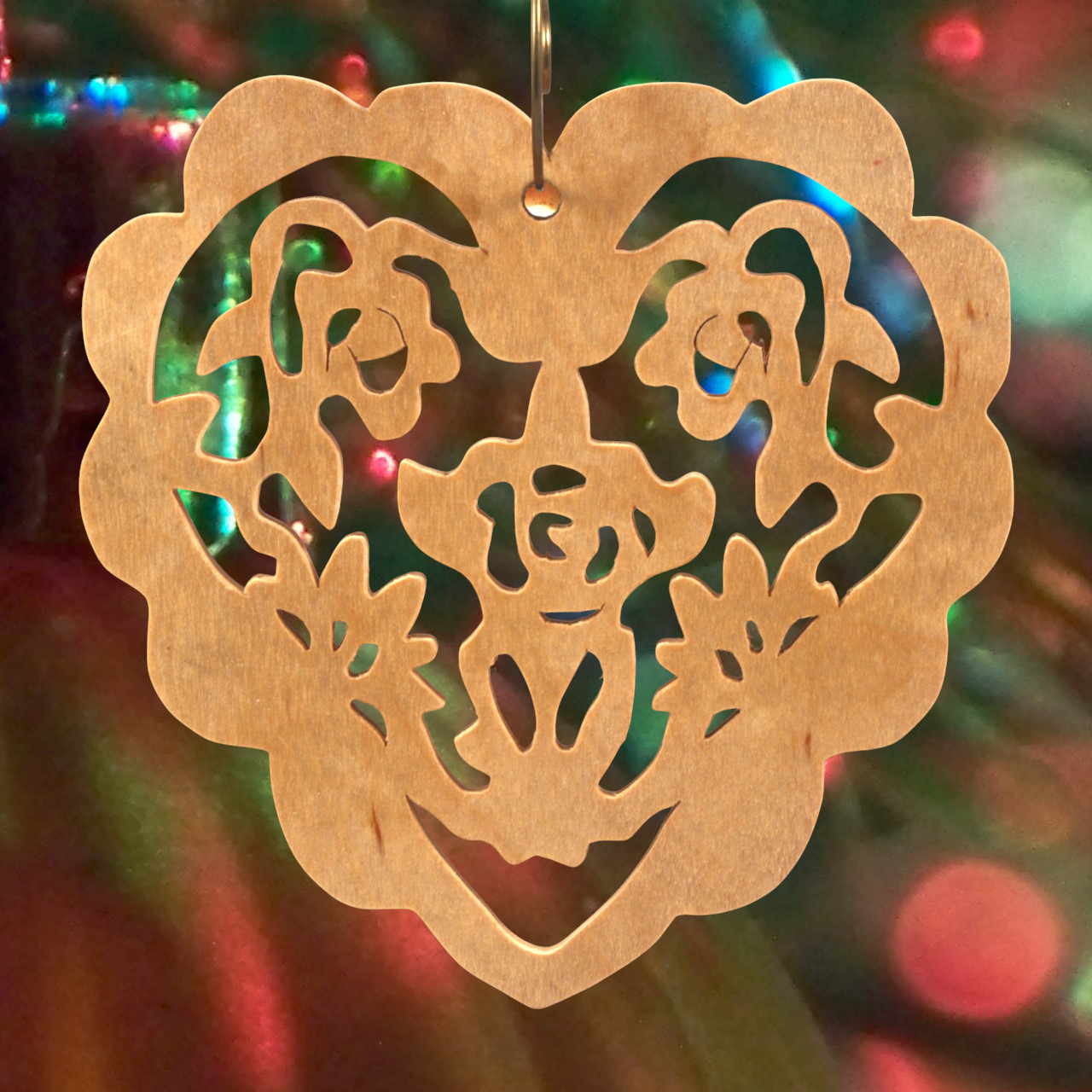 A handmade wooden Victorian-style fretwork floral heart Christmas tree ornament, featuring intricate cutout floral patterns in a heart shape, with a warm natural wood finish.