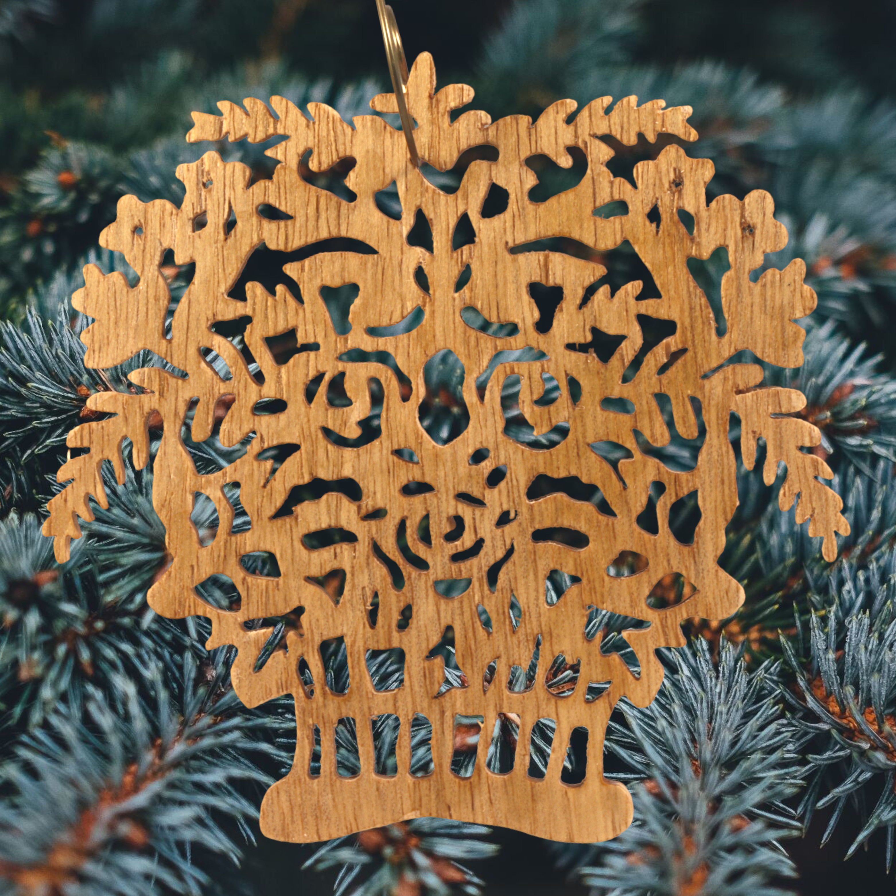 A handcrafted Victorian-style wooden Christmas tree ornament shaped like a basket filled with intricate floral designs, featuring detailed leaves and blossoms, with a small hook at the top for hanging.