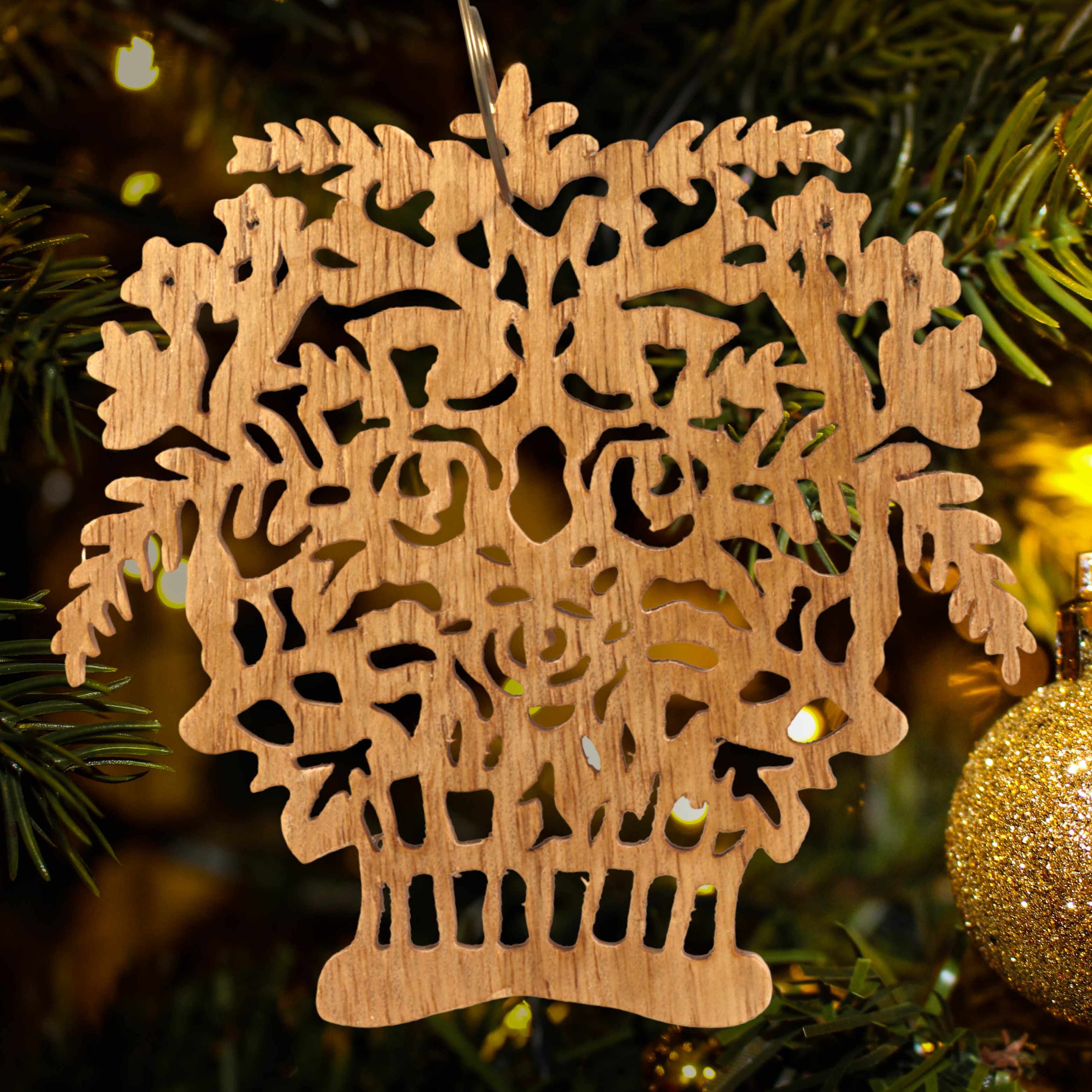 A handcrafted Victorian-style wooden Christmas tree ornament shaped like a basket filled with intricate floral designs, featuring detailed leaves and blossoms, with a small hook at the top for hanging.