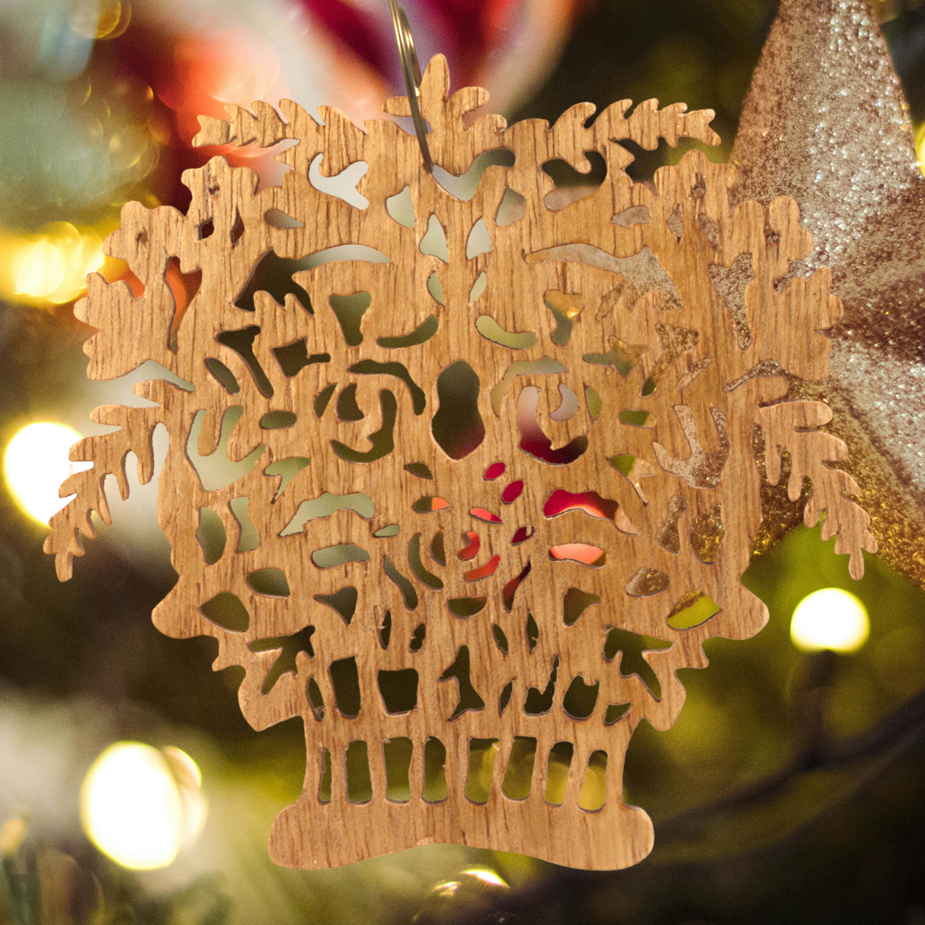 A handcrafted Victorian-style wooden Christmas tree ornament shaped like a basket filled with intricate floral designs, featuring detailed leaves and blossoms, with a small hook at the top for hanging.