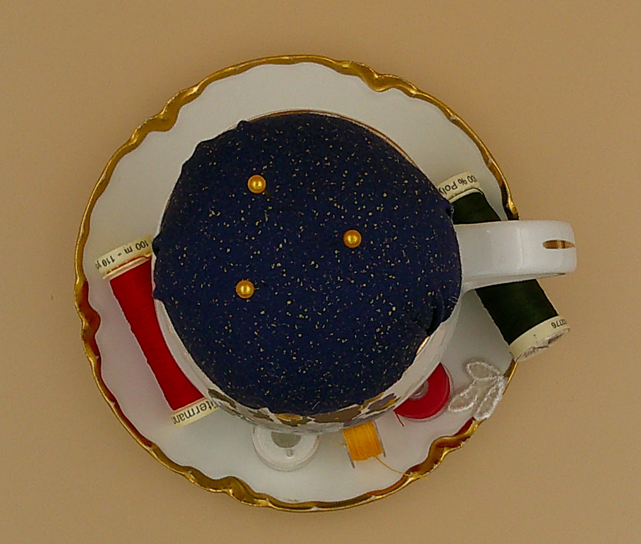 This is a view looking from the top down. It provides a good view of the trim on the saucer as well as the leaves. This is a view looking from the top down. It provides a good view of the trim on the saucer as well as the leaves.