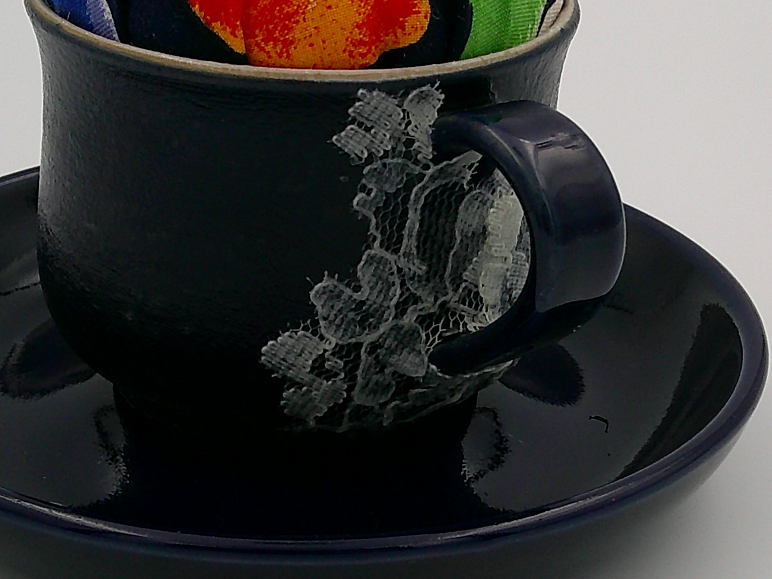 This is the front side of the lace decoupage on the cup. It's a nice contrast with the matte finish against the shiny saucer and handle. This is the front side of the lace decoupage on the cup. It's a nice contrast with the matte finish against the shiny saucer and handle.