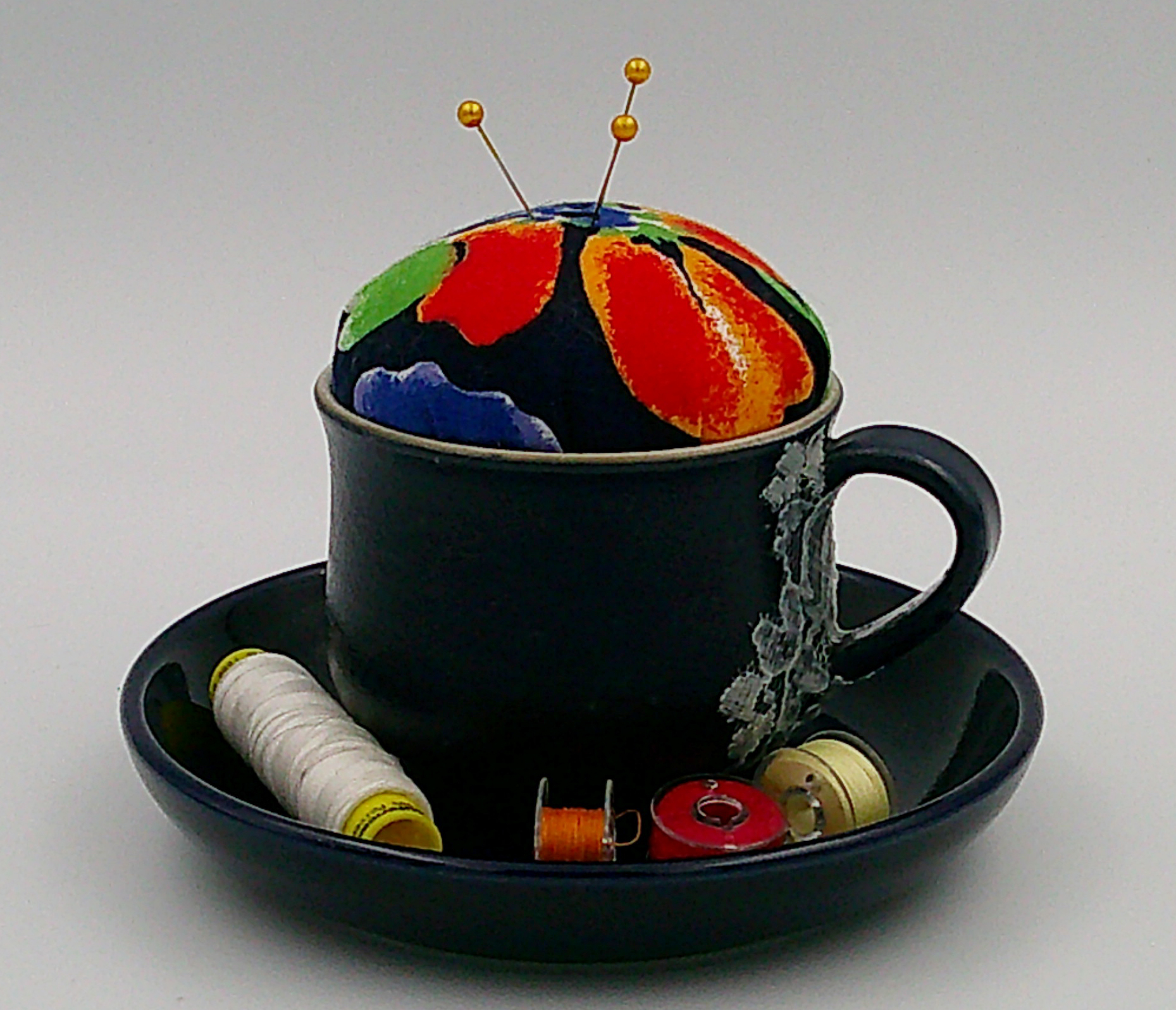 This is an example of thread and bobbins in the holder. They are NOT included with the piece. This is an example of thread and bobbins in the holder. They are NOT included with the piece.