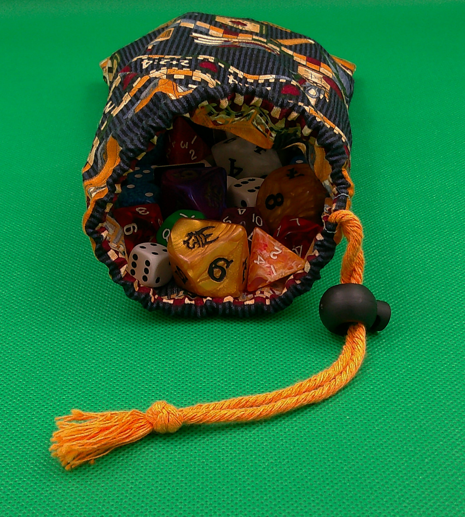 This is showing the opening of the bag with the dice inside. This is showing the opening of the bag with the dice inside.