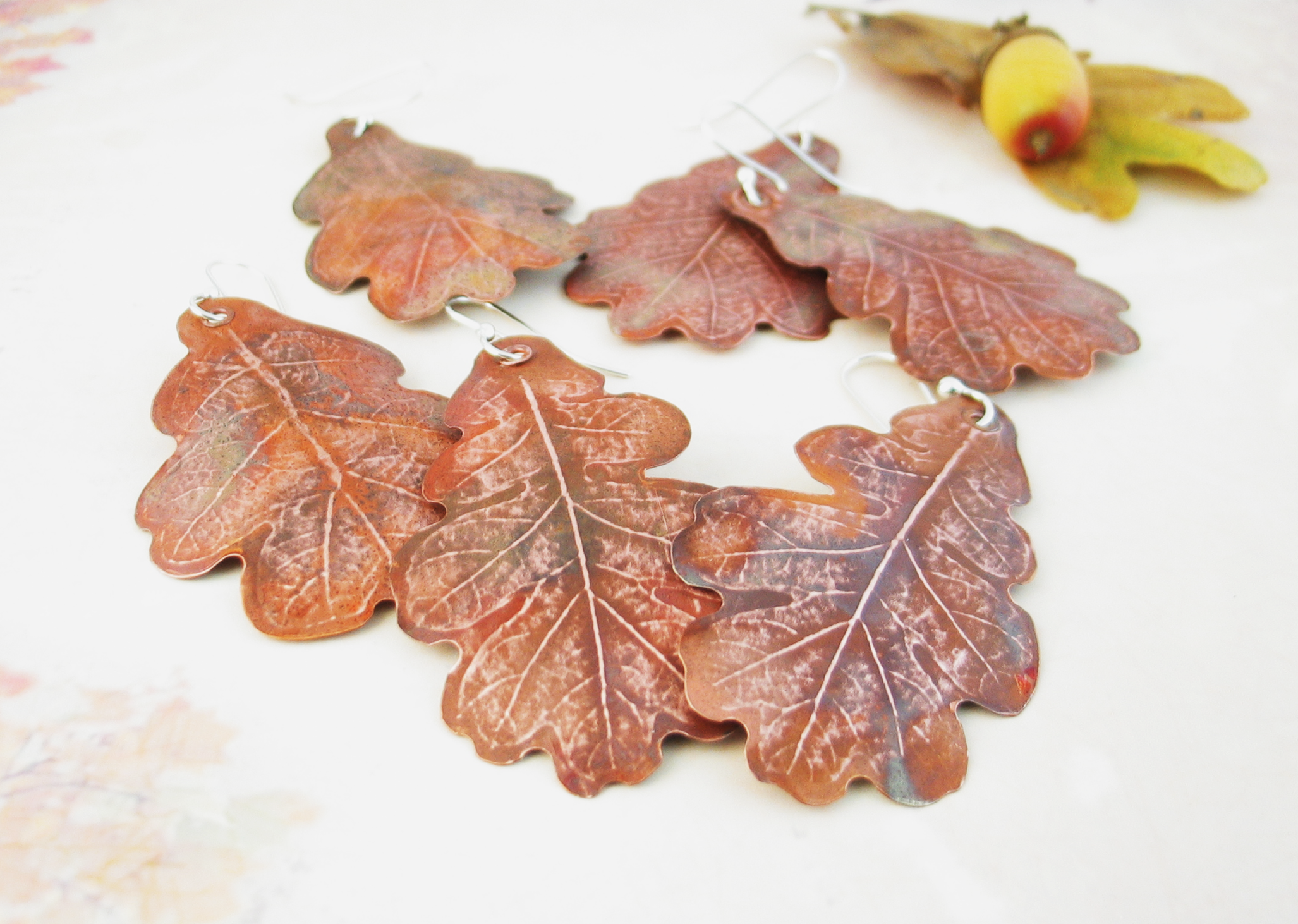 grouping of three pairs of large copper oak leaf earrings