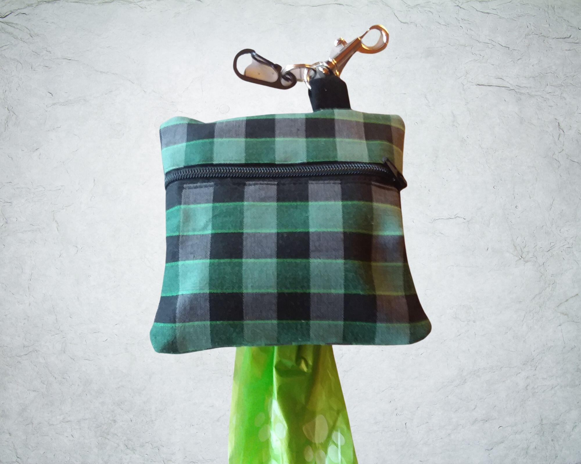 Black and green plaid poop bag holder or treat bag . 4 x 4 inches and comes with a free roll of bags.  Zipper Close and clip to hold used bags.