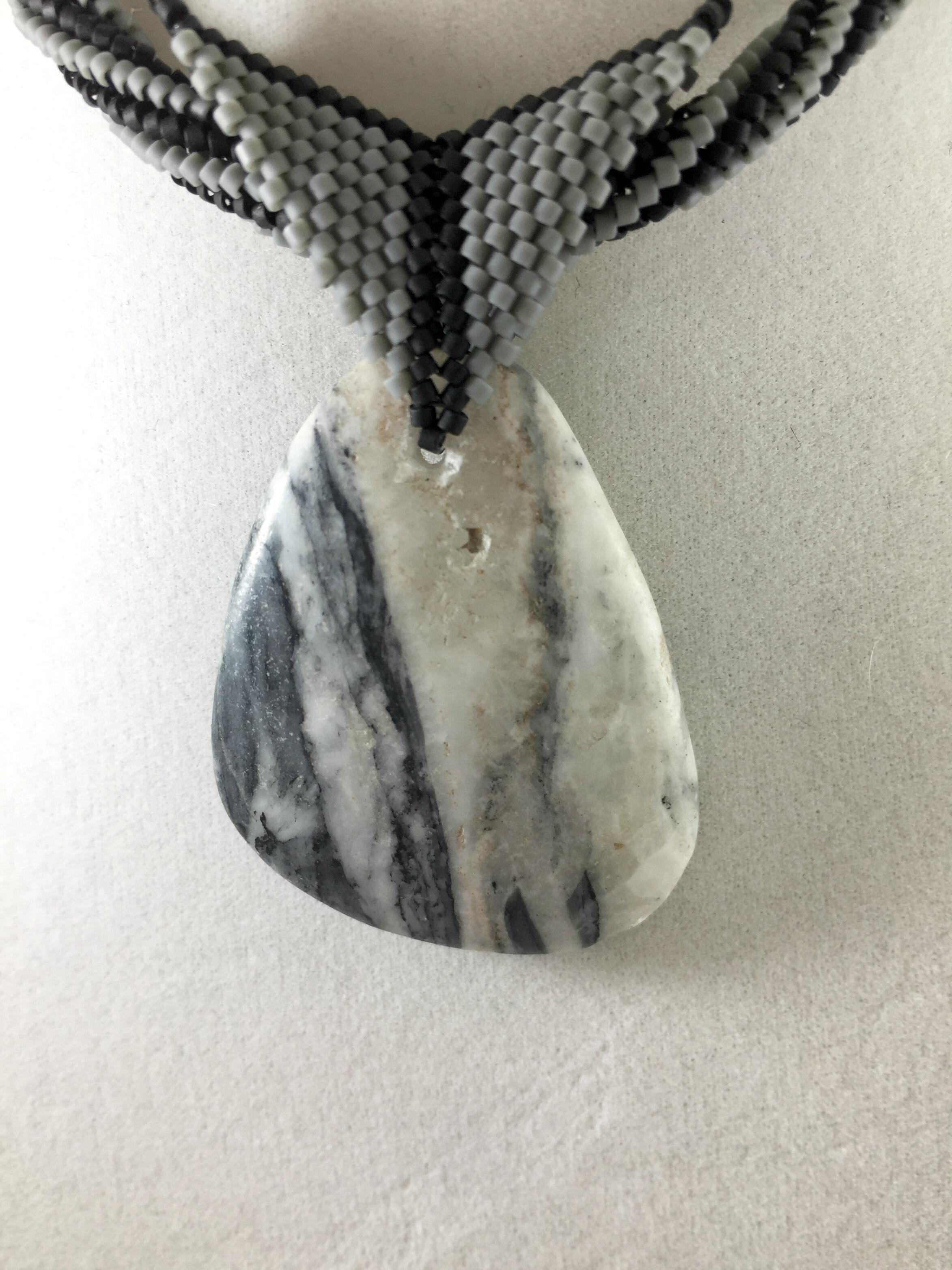 Close up image of grey and black beaded bail