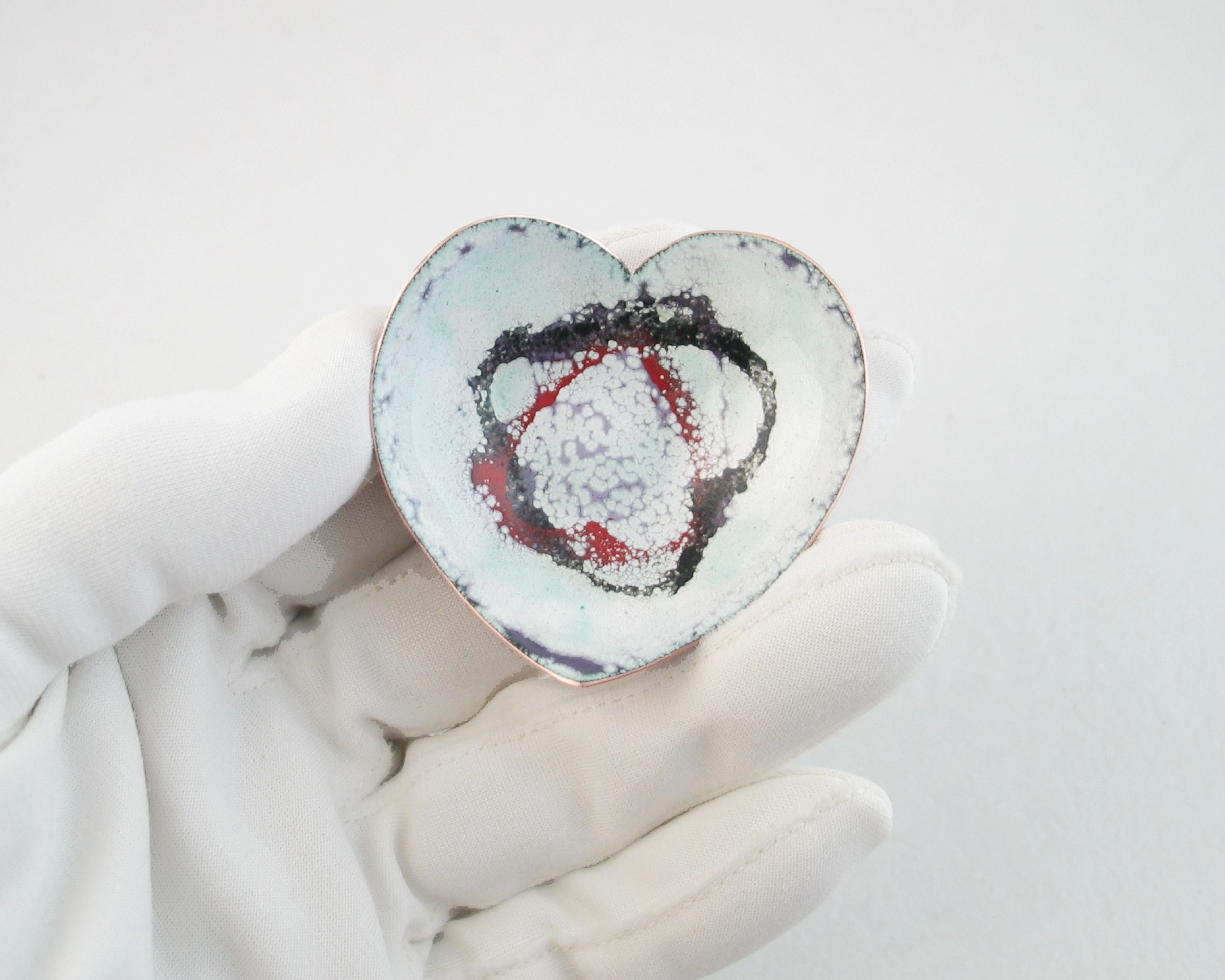 heart shaped copper enameled trinket ring dish with black and red hearts stenciled on shite, verdigris, purple