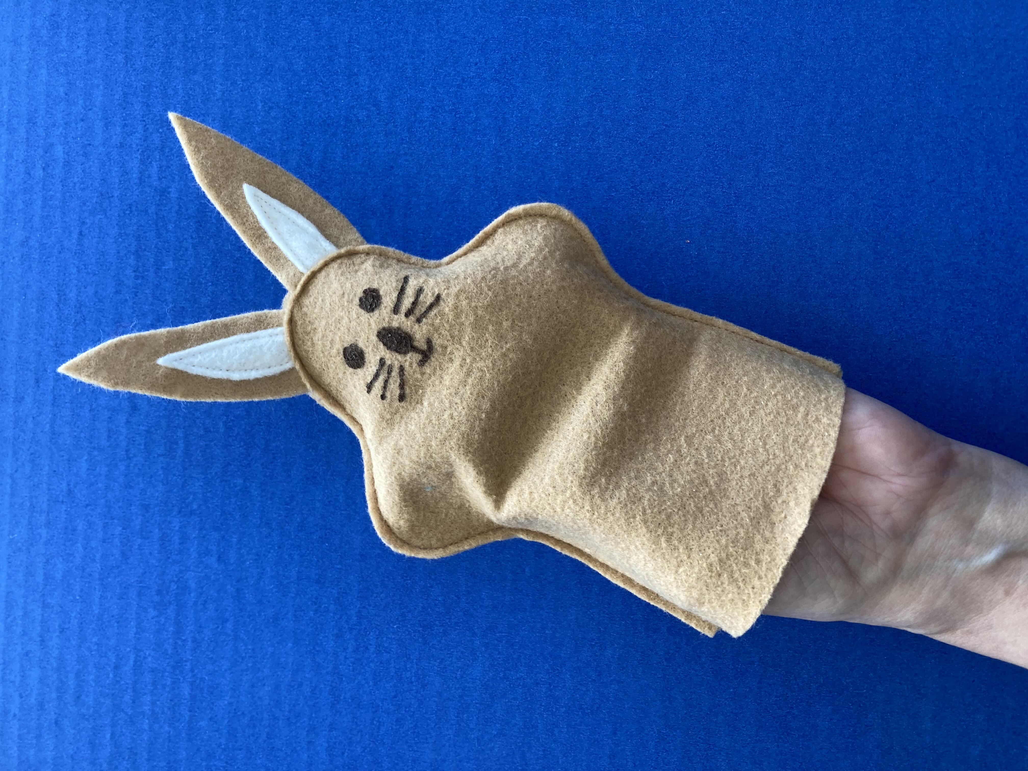 Rabbit puppet for child, shown on adult hand