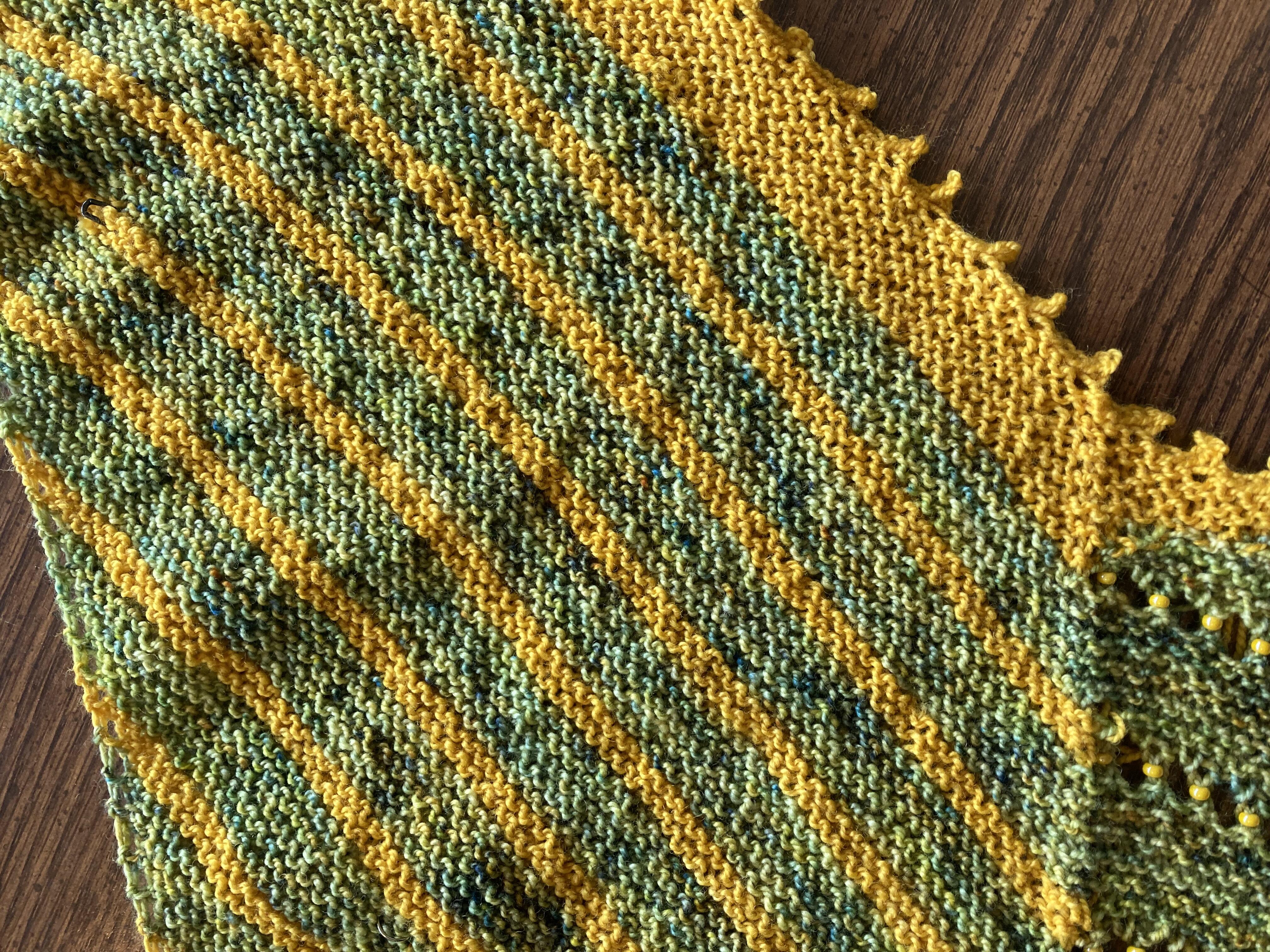 Green and yellow hand knit beaded shawl with picot edge