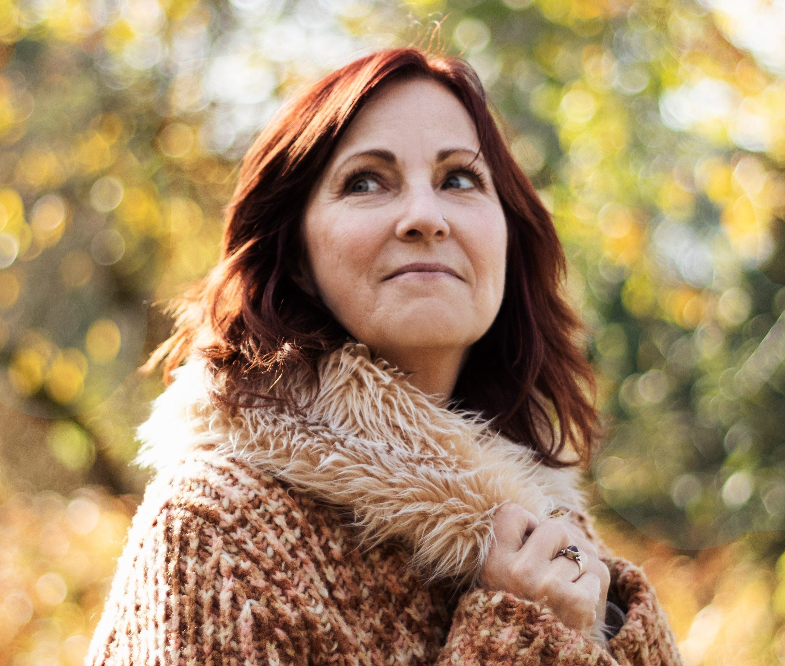 Image of Christina in fall in a sweater.