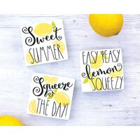 Summer Lemon Signs, Lemon Quotes on painted white wood with bright yellow lemons with green leaves and lemon slices, and a whimsical font.