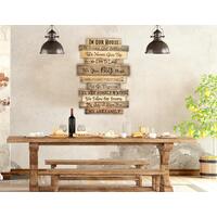 A rustic Family rules wood sign hanging in a dining area of a lodge mountain home. This sign is made up with eleven boards hanging together