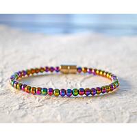 Magnetic bracelet handcrafted with iridescent rainbow hematite magnetic beads. Bracelet is secured with a strong and easy-to-use magnetic clasp. Magnetic bracelet handcrafted with iridescent rainbow hematite magnetic beads. Bracelet is secured with a strong and easy-to-use magnetic clasp.