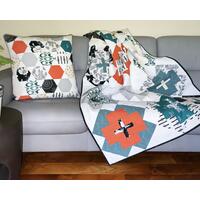 Handmade quilt, 44 X 58, various modern print fabrics in teal, burnt orange, black and ivory on white, floral backing; comes with 20" matching pillow