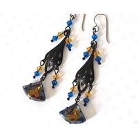 Black brass dangle earrings, with two tone blue and topaz glass and crystals. Black brass dangle earrings, with two tone blue and topaz glass and crystals.