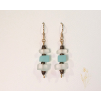 Aqua blue and white tumbled glass earrings with the look of sea glass featuring brass accents and durable 14 K gold filled ear wires Aqua blue and white tumbled glass earrings with the look of sea glass featuring brass accents and durable 14 K gold filled ear wires