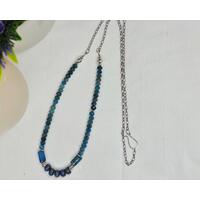 27 inch boho, beachy necklace features blue tumbled porcelain beads and blue apatite beads on stainless steel chain with a handcrafted hook clasp.
