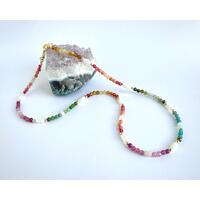 Mix of semi-precious gemstones and pearls, accented with gold detail. Delicate, colorful, a focal point for any solid-color outfit. Mix of semi-precious gemstones and pearls, accented with gold detail. Delicate, colorful, a focal point for any solid-color outfit.