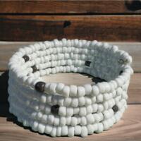 white five-tiered memory wire bracelet made with glass seed beads.