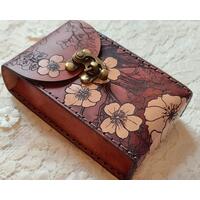 This is a Premium Leather Tarot Card Case covered on the front, back bottom and top with cherry blossoms - or Sakura. It's a handmade tarot deck box which has been hand dyed in Mahogany & Natural Tan, and hand stitched in dark graphite grey. There's much to love about this Japanese inspired floral tarot card holder.
This premium leather case is hand dyed in Mahogany and Natural Tan. The mahogany dye produces an antique look with many shades of red tones that wash over the entire case. The natural character of the real full grain leather combined with the hand dying process makes each case unique. Select flowers are highlighted with a natural tan finish which creates a bold contrast against the mahogany background.
Featuring artwork permanently etched into the leather in black:
The Sakura / Cherry Blossom art has been permanently engraved into the leather. The sakura branches and blossoms move completely around the case front to bottom to back to top, creating a wonderful flow and energy about it. This is a Premium Leather Tarot Card Case covered on the front, back bottom and top with cherry blossoms - or Sakura. It's a handmade tarot deck box which has been hand dyed in Mahogany & Natural Tan, and hand stitched in dark graphite grey. There's much to love about this Japanese inspired floral tarot card holder.
This premium leather case is hand dyed in Mahogany and Natural Tan. The mahogany dye produces an antique look with many shades of red tones that wash over the entire case. The natural character of the real full grain leather combined with the hand dying process makes each case unique. Select flowers are highlighted with a natural tan finish which creates a bold contrast against the mahogany background.
Featuring artwork permanently etched into the leather in black:
The Sakura / Cherry Blossom art has been permanently engraved into the leather. The sakura branches and blossoms move completely around the case front to bottom to back to top, creating a wonderful flow and energy about it.