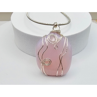 Pink glass pendant, 2 inches long, 1 inch wide, wrapped in silver wire hung on 24 inches of French Bullion stainless steel wire