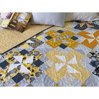 handmade quilt, 56 X 70, shades of yellow and gray; scrappy look with folk-themed prints mixed with solids and stripes; gender neutral handmade quilt, 56 X 70, shades of yellow and gray; scrappy look with folk-themed prints mixed with solids and stripes; gender neutral