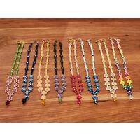 The Whimsy family of necklaces. Left to right: Cherry Blossom, Glacier, Tangerine, Passion Flower, Flame, Ocean, Daisy, and Rainbow