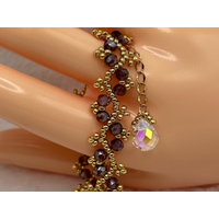 Purple Bicone Crystal and Gold tone Miyuki Seed Beads in a beautifully handmade, woven, unique and sparkly bracelet. A perfect gift!