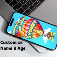 colorful hot air balloon with dogs in the basket, personalized happy birthday message with 5 (age) in yellow text against a clouded sky blue background on a cellphone