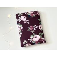 This floral book sleeve has a maroon background with red and off maroon roses This floral book sleeve has a maroon background with red and off maroon roses