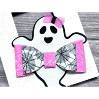 White & black ghost shaped bow, w/ pink glitter spider web design. Ghost is wearing tiny pink bow.  Bow is approx. 3 x 3. Sold Individually. White & black ghost shaped bow, w/ pink glitter spider web design. Ghost is wearing tiny pink bow.  Bow is approx. 3 x 3. Sold Individually.