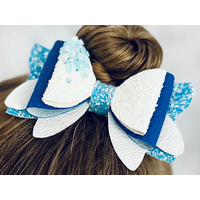 My 4 year old modeling a blue and white glitter 4 layer bow. Top left corner of bow has dripping iridescent blue rhinestones. My 4 year old modeling a blue and white glitter 4 layer bow. Top left corner of bow has dripping iridescent blue rhinestones.
