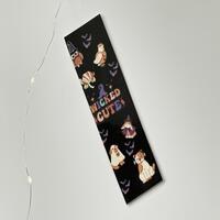 this Halloween bookmark as a black background with the words 'Wicked Cute' in the middle animals dressed up in Halloween costumes, and little bats flying