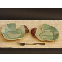 Bride & Groom's Table ceramic heart shaped dinner plate set with Hosta plant texture. Glazed in teal with maroon on adjacent edges. 8"x9" Bride & Groom's Table ceramic heart shaped dinner plate set with Hosta plant texture. Glazed in teal with maroon on adjacent edges. 8"x9"