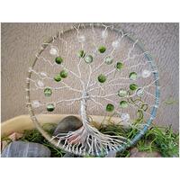 front of tree of life. branches ae made carefully by twisting and turning aluminum wire. decorated with green crackle glass beads