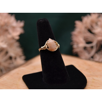 The image shows a gold ring with a peach moonstone double point gemstone wire wrapped with 14K gold-filled wire. 