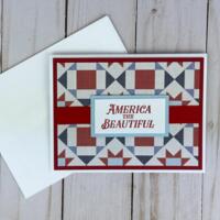 A 4th of July card making kit with cardstock, quilt scrapbook paper, stamped sentiments and mats, ribbons and cards and envelopes.