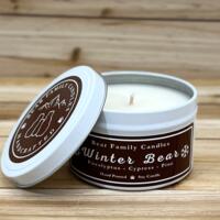 Pine and eucalyptus scented soy candle in 6oz tin with lid off.