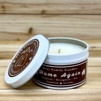 Fir tree scented soy candle in 6oz tin with lid off. 