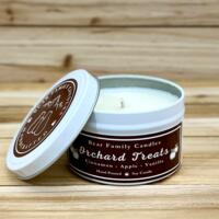 Apple cider scented soy candle in 6oz white tin with lid off.