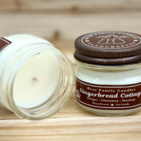 Gingerbread scented soy candle in 4oz jar. One jar standing up with lid on and one jar on its side with lid off.
