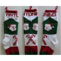 Santa faces and candy canes on hand knit Christmas stocking Santa faces and candy canes on hand knit Christmas stocking
