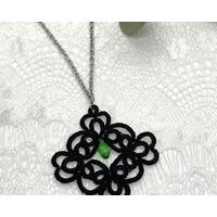 Black lace pendant with faceted green crystal Black lace pendant with faceted green crystal