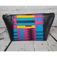 Pink blue and orange geometric print makeup bag with black faux leather accents, silver top zipper and silver Bass Creations logo. Pink blue and orange geometric print makeup bag with black faux leather accents, silver top zipper and silver Bass Creations logo.