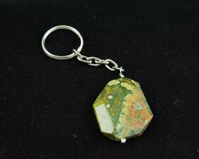 Green and brown stone with key ring attached by a chain.