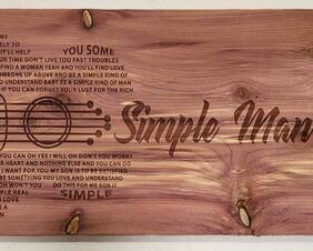 Simple man lyrics on unique wood.